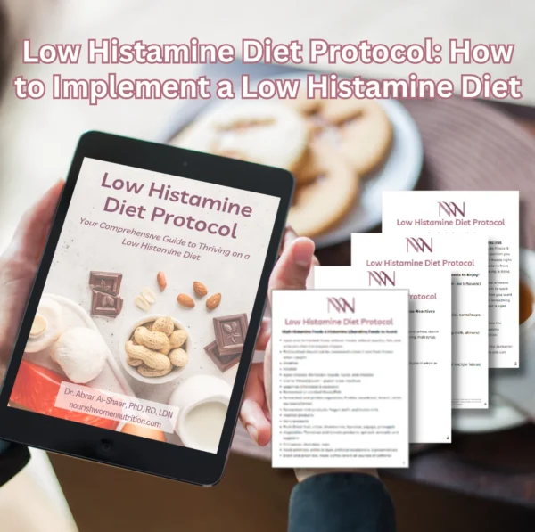 The image shows a digital tablet and several printed documents arranged on a surface, presumably a workspace. The tablet screen displays the cover of a publication titled "Low Histamine Diet Protocol," which is described as "Your Comprehensive Guide to Thriving on a Low Histamine Diet." The same cover design from the tablet is echoed on the visible printed documents around it, suggesting these are part of the eBook or handout materials from the guide. The documents contain various amounts of text and some graphical elements. The cover on the tablet features the author's credentials, "Dr. Abrar Al-Shaer, PhD, RD, LDN," and a website, "nourishwomennutrition.com." The tablet is resting on a person's lap, with their fingers holding it in place, and the overall setting appears to be conducive to reading or studying. The arrangement conveys a sense of in-depth information available in both digital and print formats for individuals interested in a low histamine diet.