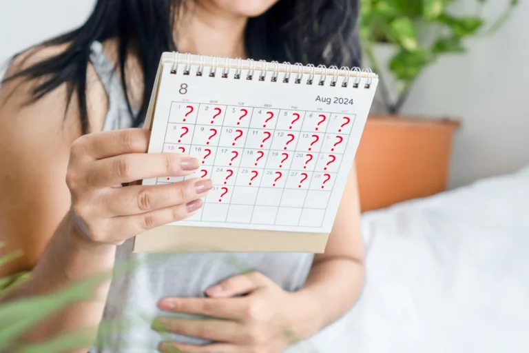 Woman holding a calendar marked with question marks, indicating uncertainty about a missed period
